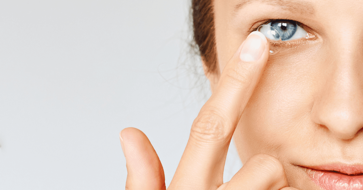 woman new to contact lenses places contact lens in eye