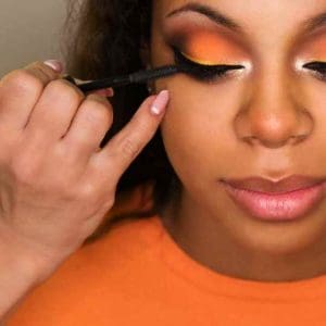 woman applying eye makeup mascara