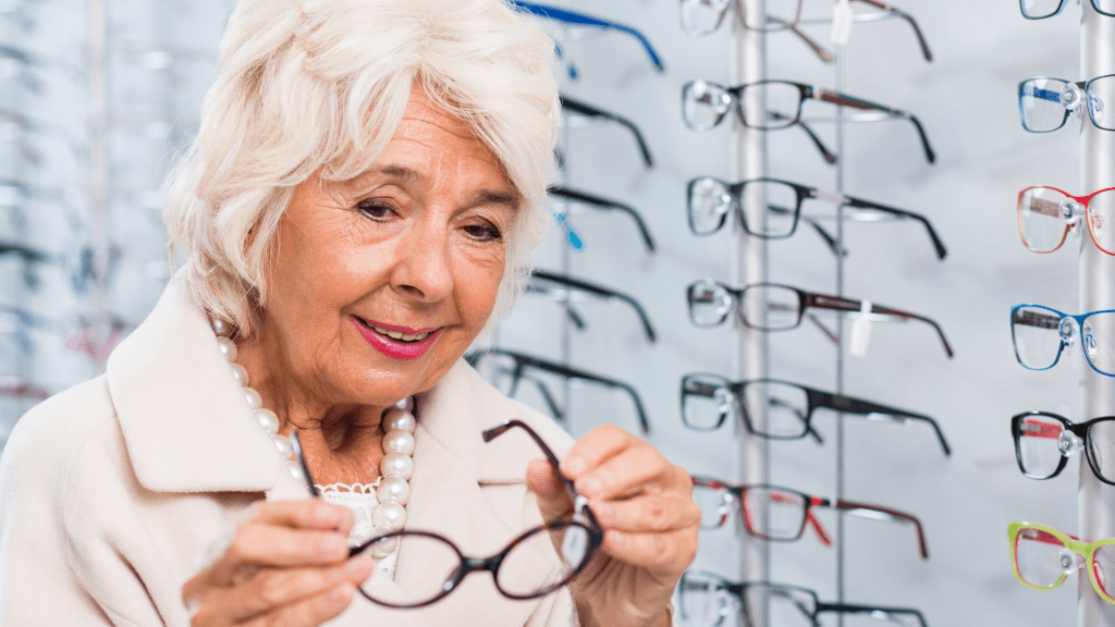Woman trying on styles of Eye glasses from glasses wall at the Eye center