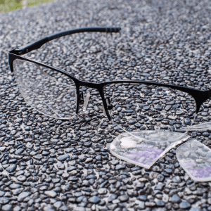 broken eyeglasses laying on pavement