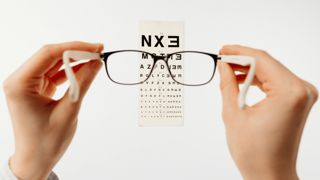 eye chart with person holding glasses