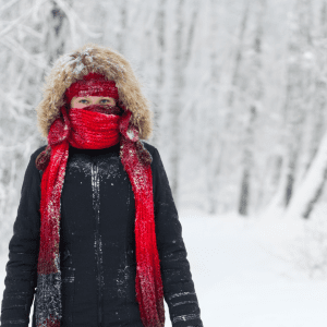 cold person standing in the snow with face wrapped to Protect Eyes During Winter Weather