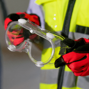 worker holding safety eye glasses