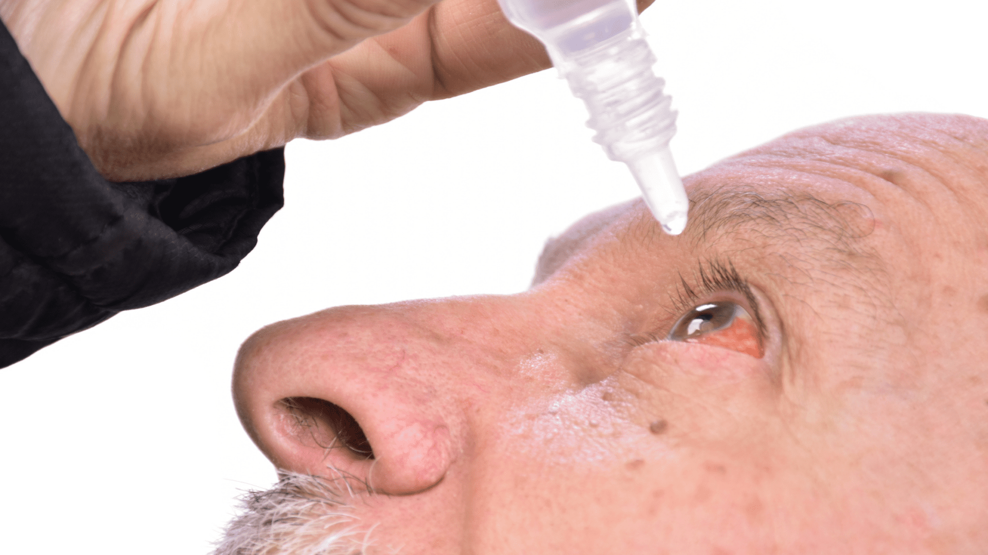 Man using eye drops